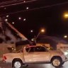 Footage shows a ute with green and red fireworks flaring out driving along a main road in Sydney’s south-west,