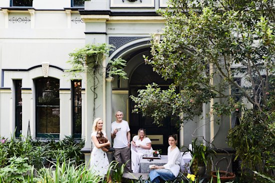 Isabella, holding Bowie, with Ross, Natalie and Sascha in the lush garden, which is planted with camellias, orchids, peonies and tulips.