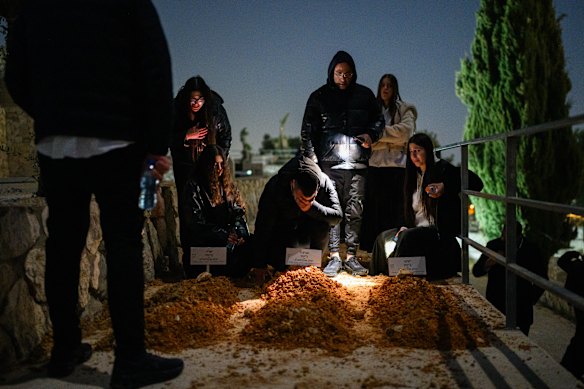 Friends and relatives mourn three siblings, Yaakov, Avigail and Sarah Biton at the Mount Olives Cemetery in Jerusalem.