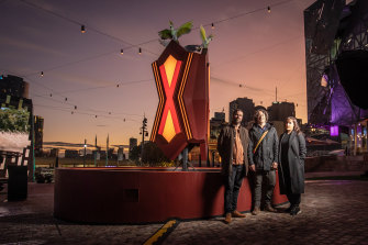 From left to right, Kristian Laemmle-Ruff, artist Kent Morris, and Grace Darling Armand, who have collaborated on a sculpture at Fed Square to mark Reconciliation Week. Laemmle-Ruff and Armand are from Studio John Fish.