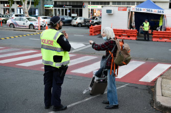 Police speak to a pedestrian at Coolangatta’s Griffith Street border check in December.