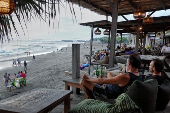 Locals and foreigners soak up life by the beach in Bali last week.
