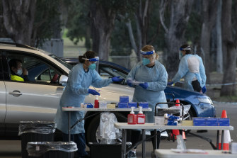 SydPath staff conduct COVID-19 tests at the 24-hour drive-through clinic at Fairfield Showground on Thursday.