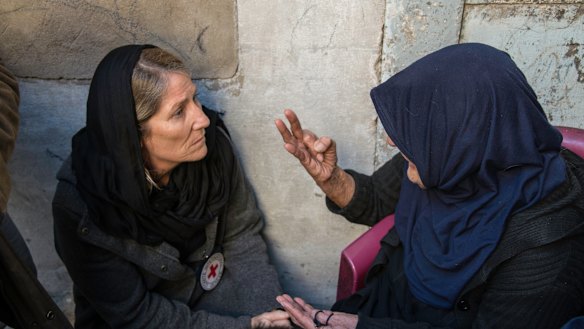 The head of the ICRC's Iraq delegation, Katharina Ritz, listens to an old woman who lost her whole family, her home and hope in an airstrike.
