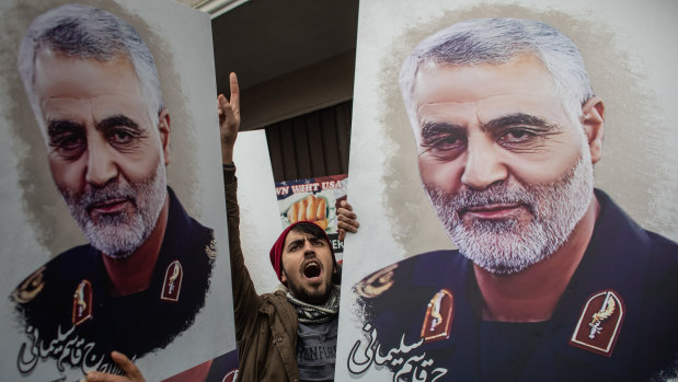 People hold posters of slain Iranian Revolutionary Guard Major General Qassem Soleimani during a protest outside the US Consulate in Turkey on Sunday. 