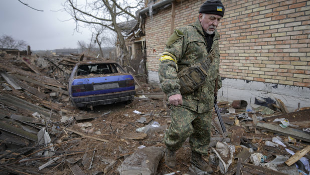 Andrey Gonchruk, 68, walks in the backyard of a house damaged by a Russian airstrike.