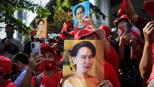People hold up images of Myanmar’s de-facto leader Aung San Suu Kyi at a protest outside Maynmar’s embassy in Bangkok, Thailand. 