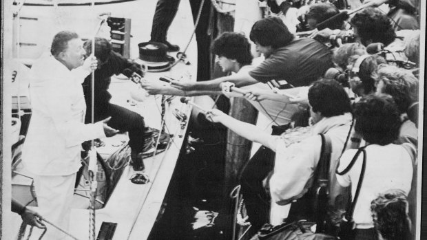 Alan Bond holds a press conference from Australia II after it won the fifth of seven races.