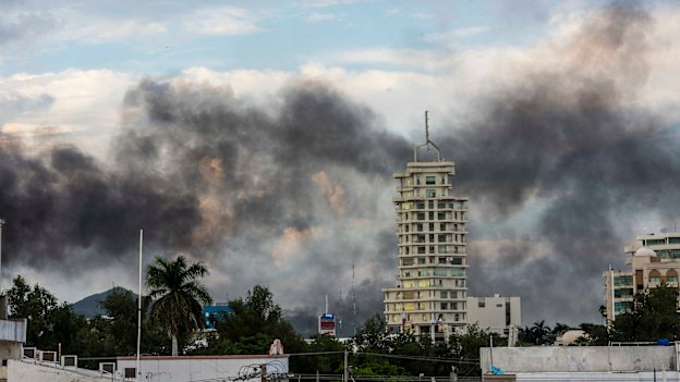Smoke from burning cars in Caliacun as cartel members attempt to force the government to free a drug lord. 