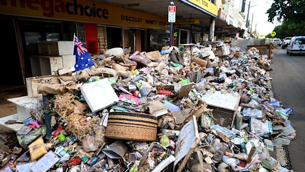 Piles of flood-damaged goods line a main street in central Lismore.       