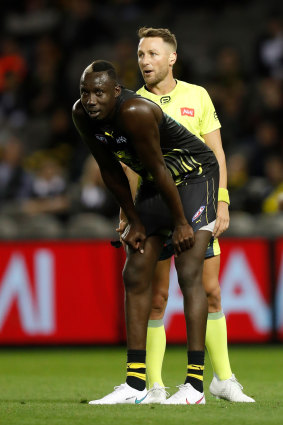 Umpire Brett Rosebury looks on as Mabior Chol of the Tigers mans the mark against Collingwood last week.