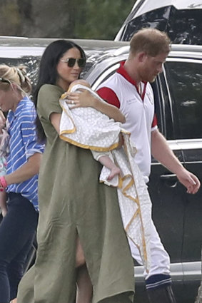 Meghan, Duchess of Sussex, with baby Archie, Prince Harry and her roomy yet chic linen sack dress. 