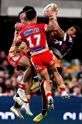 Tristan Sailor of the Broncos and Hamiso Tabuai-Fidow of the Dolphins compete for the ball during the Battle of Brisbane at The Gabba on Saturday.