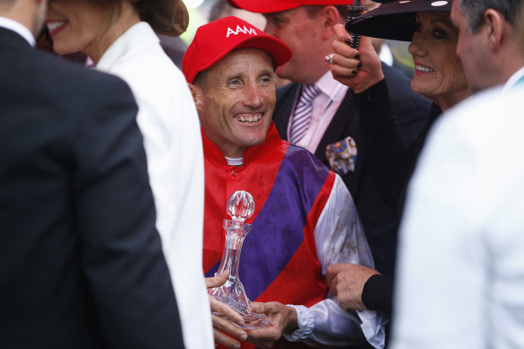Trophy boy: Damien Oliver smiles after his Derby day victory with Warning. 