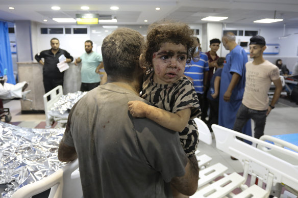Wounded Palestinians arrive at hospital, following Israeli airstrikes on Gaza City,