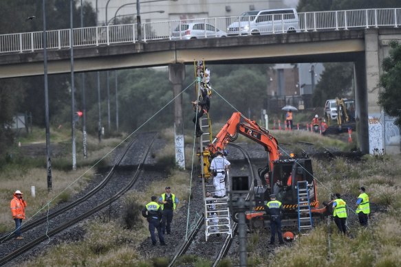 Protestors tied to a pole push for climate change action on a cargo train line near Port Botany in Pagewood on March 24.