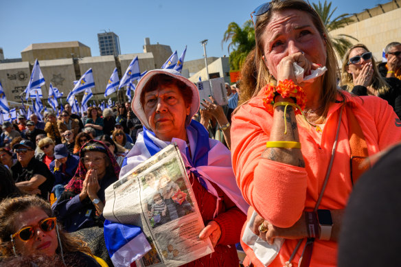 Mourners watching the live feed of the funeral in Tel Aviv.