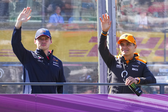 Red Bull driver Max Verstappen of the Netherlands and McLaren driver Lando Norris of Britain wave during the drivers parade ahead of the Australian Formula One Grand Prix.