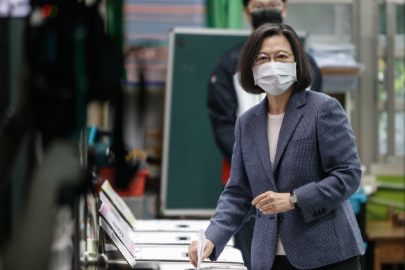 Taiwanese President Tsai Ing-wen casts her ballots at a polling station in Taipei on Saturday. 