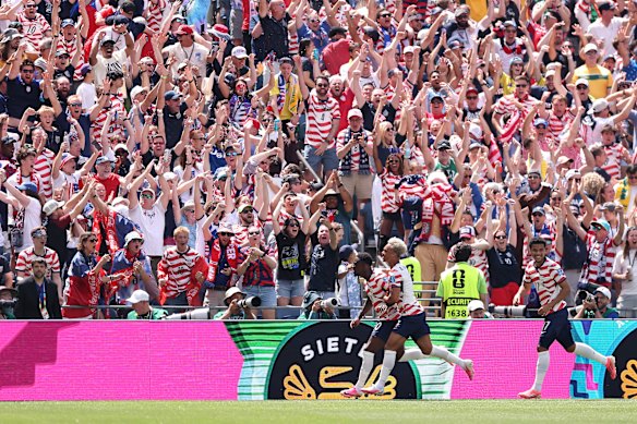 The United States celebrate the own goal by Cameron Burgess.
