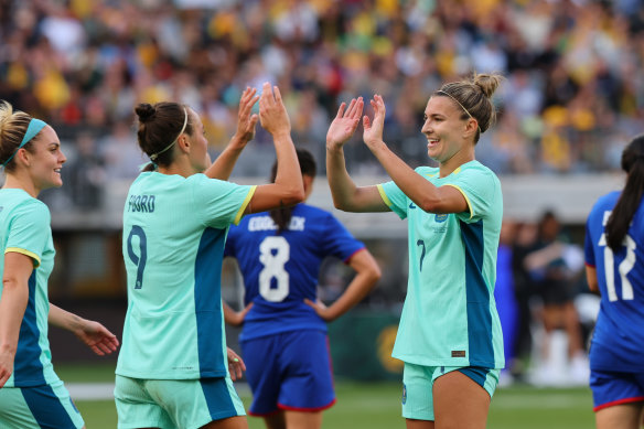 Caitlin Foord and Steph Catley celebrate at full-time.