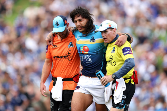 Tino Fa’asuamaleaui is helped from the field.