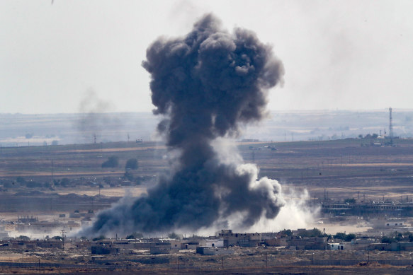 Smoke rises over the Syrian town of Ras al-Ain, as seen from the Turkish border town of Ceylanpinar on October 12, 2019 in Ceylanpinar, Turkey. 