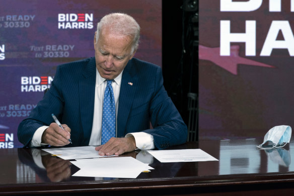 Joe Biden signs his official nomination paperwork.