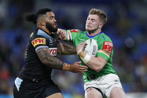 Raiders forward Hudson Young attempts to fend off Cronulla’s Siosifa Talakai.