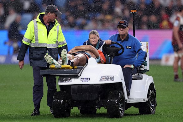 Joseph-Aukuso Suaalii of the NSW Waratahs is taken off the field. 
