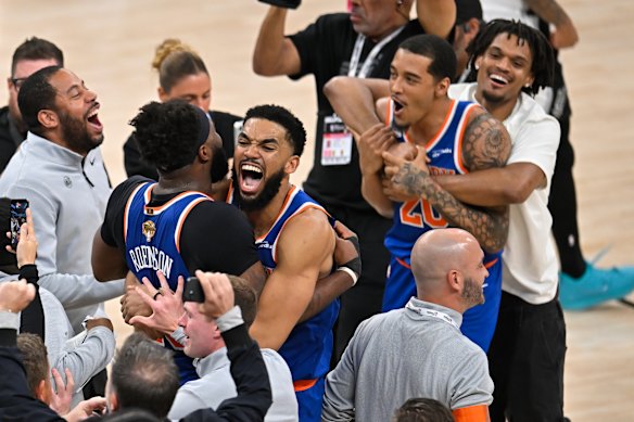 New York Knicks center Karl-Anthony Towns, right, hugs forward Og Anunoby during the after defeating the San Antonio Spurs to win the NBA title.