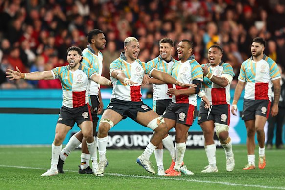 Rob Leota (blonde hair) of the First Nations & Pasifika celebrates after scoring a try.