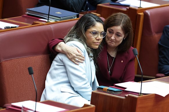 An emotional Senator Jacinta Nampijinpa Price is comforted by Liberal colleague Senator Sarah Henderson.