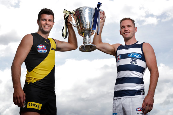 Richmond captain Trent Cotchin (left) and Geelong counterpart Joel Selwood with the premiership cup.