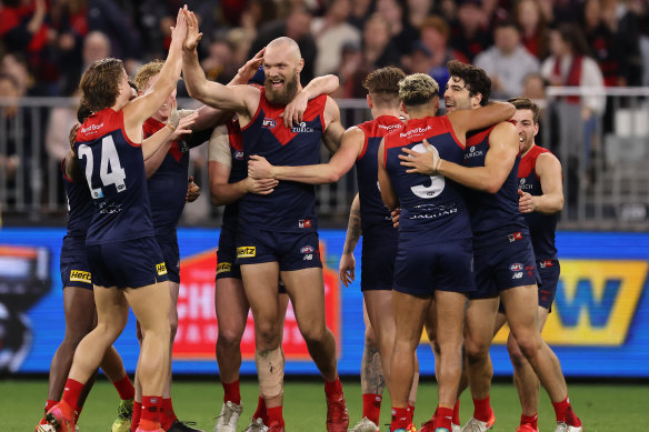 Max Gawn celebrates with teammates after scoring in Melbourne’s thumping win over Geelong.