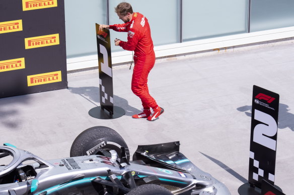 Vettel switches the standing markers post-race to vent his displeasure at the time penalty which cost him the victory.