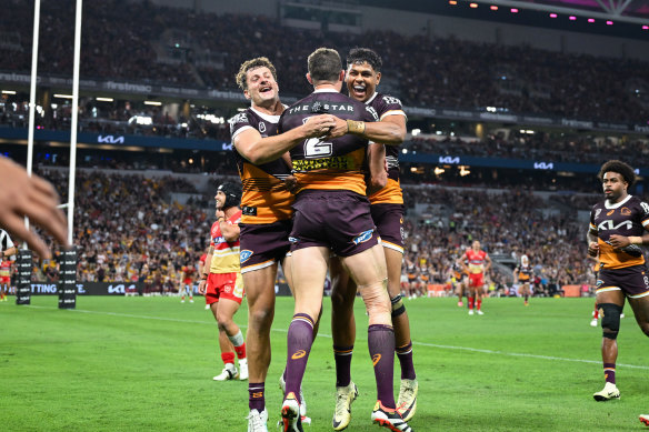 Corey Oates celebrates scoring for the Brisbane Broncos against the Dolphins.