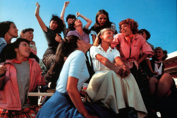 Olivia Newton-John (centre) with Didi Conn (right, in pink) singing Summer Lovin' in Grease.