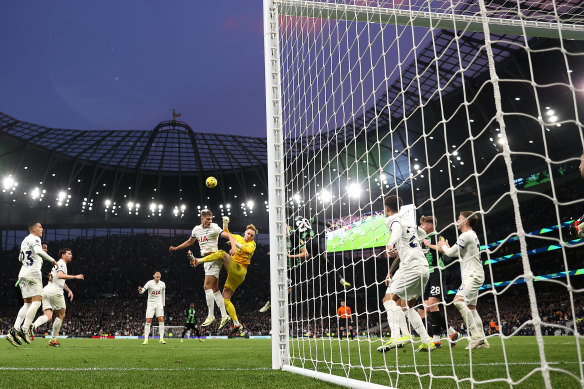 Micky van de Ven of Spurs clashes in the air with Jason Steele of Brighton.