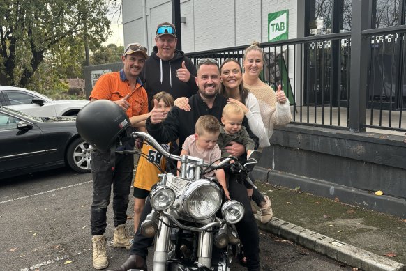 Brady Morton (centre) with his family and the bike.