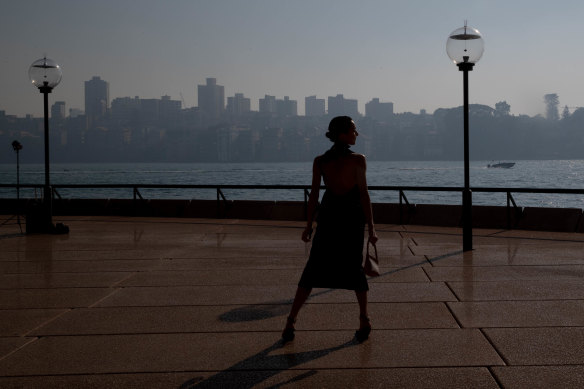 A model appearing at the launch of Australian Fashion Week is seen against a backdrop of the haze hanging over Sydney Harbour on Tuesday morning. 