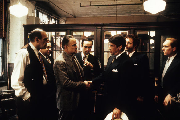 As Vito Corleone, Marlon Brando grants favours in his darkened office in a scene from The Godfather.
