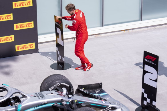 Ferrari driver Sebastian Vettel switches the standing markers post-race to vent his displeasure at the time penalty which cost him the victory.