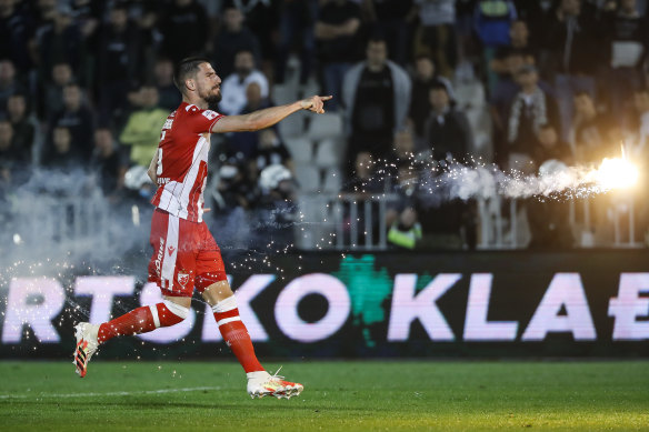 Milos Degenek carries a flare off the field during last year’s Serbian Cup semi-final.