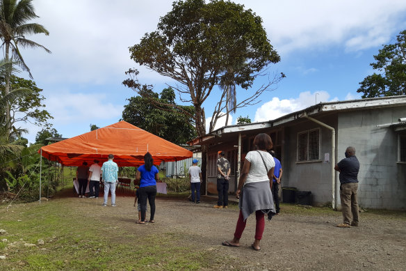 People queue for a COVID-19 vaccination in Suva, Fiji, last month.