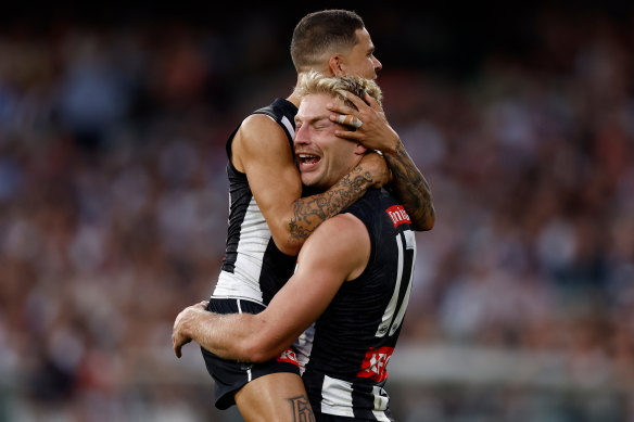 Bobby Hill (left) hugs Pies teammate Billy Frampton during the Anzac Day clash.