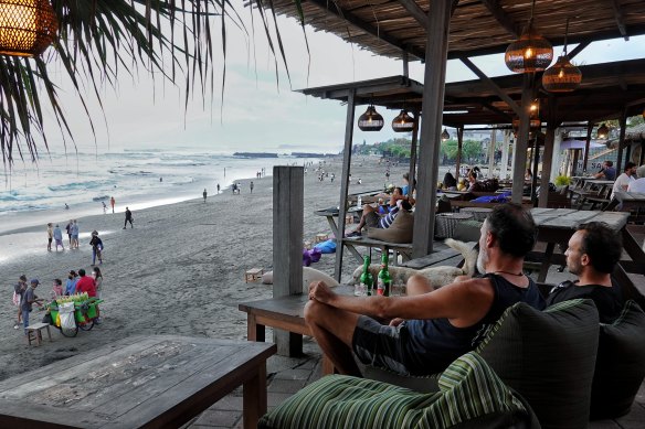 Locals and foreigners soak up life by the beach in Bali last week.