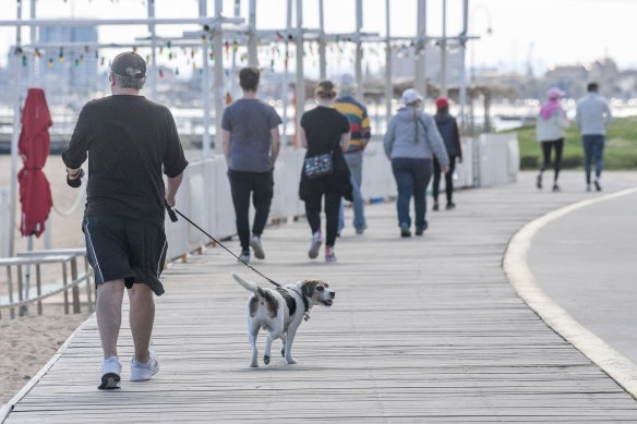 People enjoying some fresh air and a walk at St Kilda beach on Wednesday.