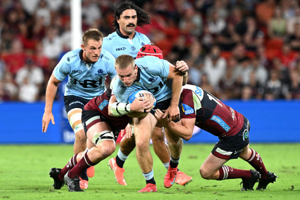 Max Jorgensen of the Waratahs is tackled against the Reds
