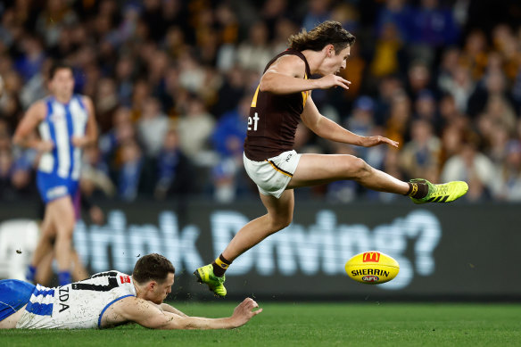 Hawthorn’s Connor Macdonald escapes the clutches of North Melbourne’s Lachie Young.